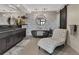 Modern bathroom featuring double vanities, a soaking tub, decorative stone wall, and a chaise lounge at 3520 Castle Butte Dr, Castle Rock, CO 80109