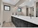 Bathroom with double vanity featuring undermount sinks and dark wood cabinets with large mirror at 3520 Castle Butte Dr, Castle Rock, CO 80109