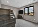 Neutral bedroom with a built-in bunk bed, dresser, and a large window showcasing the outside at 3520 Castle Butte Dr, Castle Rock, CO 80109