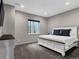 Comfortable bedroom with a large bed, dresser, and window with exterior view at 3520 Castle Butte Dr, Castle Rock, CO 80109