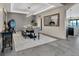 Elegant dining room features designer lighting, tray ceiling, large mirror, and view into adjacent open kitchen at 3520 Castle Butte Dr, Castle Rock, CO 80109