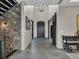 Inviting entryway with stone accent wall, high ceilings, chandelier, and decorative sliding barn door at 3520 Castle Butte Dr, Castle Rock, CO 80109