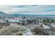 Stunning exterior elevation of luxury home features circular driveway, water feature, turfed sport court, and mountain views at 3520 Castle Butte Dr, Castle Rock, CO 80109