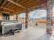 A covered outdoor patio with a built-in hot tub and stone supports at 3520 Castle Butte Dr, Castle Rock, CO 80109