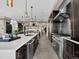 Chef's kitchen features stainless appliances, island bar with seating, and view into the breakfast nook at 3520 Castle Butte Dr, Castle Rock, CO 80109