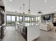 Bright, open kitchen with island bar, stainless appliances, eat-in table, and access to an outdoor deck at 3520 Castle Butte Dr, Castle Rock, CO 80109