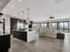 Spacious living room open to kitchen features large windows, designer lighting, stainless appliances, and sliding doors to deck at 3520 Castle Butte Dr, Castle Rock, CO 80109