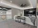 Bright living room with beamed ceiling, modern fan, media center, and comfortable seating area at 3520 Castle Butte Dr, Castle Rock, CO 80109