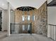 Beautiful loft area with stone walls and open chandelier at 3520 Castle Butte Dr, Castle Rock, CO 80109