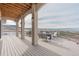 Beautiful deck with a seating area and stunning views of mountains and the surrounding landscape at 3520 Castle Butte Dr, Castle Rock, CO 80109