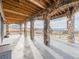 An outdoor patio with stone pillars, wood ceilings, and mountain views at 3520 Castle Butte Dr, Castle Rock, CO 80109