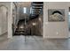 Elegant staircase features stone walls, metal railings, and tiled floors at 3520 Castle Butte Dr, Castle Rock, CO 80109