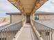 Outdoor walkway connecting two parts of the home, featuring iron railings and stone accents, creates a seamless transition at 3520 Castle Butte Dr, Castle Rock, CO 80109