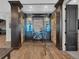 A wine cellar featuring glass doors, stone walls, and wood flooring at 3520 Castle Butte Dr, Castle Rock, CO 80109