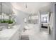 Bright bathroom featuring double sinks, soaking tub, and marble tile, flowing into the main bedroom at 1625 Larimer St # 2601, Denver, CO 80202