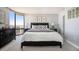 Inviting bedroom featuring a dark wood bed frame, neutral decor, and a large window with city views at 1625 Larimer St # 2601, Denver, CO 80202