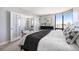 Bedroom with french doors to an office, neutral decor, and large window with city views at 1625 Larimer St # 2601, Denver, CO 80202