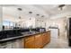Open kitchen featuring dark countertops, light-wood cabinetry, and seating area at 1625 Larimer St # 2601, Denver, CO 80202