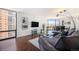 Modern living room featuring hardwood floors, city views, and a comfortable gray sofa at 1625 Larimer St # 2601, Denver, CO 80202