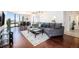 Bright and airy living room with hardwood floors, floor to ceiling windows, and a modern gray sofa at 1625 Larimer St # 2601, Denver, CO 80202