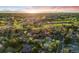 Beautiful aerial view showcases homes and a golf course with a picturesque sunset backdrop at 2777 S Elmira St # 17, Denver, CO 80231