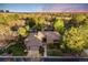 Expansive aerial view of brick home nestled among lush greenery and mature trees at 2777 S Elmira St # 17, Denver, CO 80231