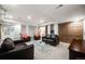 Finished basement features two leather couches, two lounge chairs, and a glass coffee table at 2777 S Elmira St # 17, Denver, CO 80231