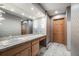 Large bathroom featuring granite countertop, unique lighting, and neutral gray tones at 2777 S Elmira St # 17, Denver, CO 80231