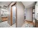 Hallway featuring unique wallpaper design that connects multiple modern bathroom suites at 2777 S Elmira St # 17, Denver, CO 80231