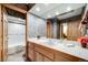Well-maintained bathroom featuring a long vanity, white countertop, and a tub with white tile surround at 2777 S Elmira St # 17, Denver, CO 80231