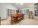Well-lit dining area with large windows, wood flooring, and a view of an easel at 2777 S Elmira St # 17, Denver, CO 80231