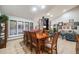 Elegant dining room featuring large windows and open to the adjacent living area at 2777 S Elmira St # 17, Denver, CO 80231