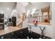 Open foyer with black tile floors, staircase, and a glimpse of the living room at 2777 S Elmira St # 17, Denver, CO 80231