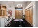 Elegant foyer with striking black tile flooring, modern chandelier and high ceilings at 2777 S Elmira St # 17, Denver, CO 80231