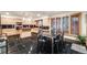 Modern kitchen with custom cabinets, black countertops, stainless appliances, tile floors, and dining table at 2777 S Elmira St # 17, Denver, CO 80231
