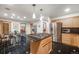 Well-appointed kitchen with stainless steel appliances, island cooktop, and view to the dining area at 2777 S Elmira St # 17, Denver, CO 80231