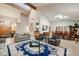 Open-concept living room with high ceilings, skylights, comfortable seating, and a dining area at 2777 S Elmira St # 17, Denver, CO 80231