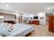 Spacious main bedroom with hardwood floors, natural light, and comfortable seating at 2777 S Elmira St # 17, Denver, CO 80231