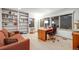 Inviting home office with large windows, built-in bookshelves, and comfortable seating area at 2777 S Elmira St # 17, Denver, CO 80231