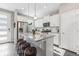 Modern kitchen with white cabinets, granite island, and stainless steel appliances at 21795 E 8Th Ave, Aurora, CO 80018