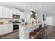 Modern kitchen with white cabinets, granite island, and stainless steel appliances at 21795 E 8Th Ave, Aurora, CO 80018