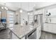 Modern kitchen with white cabinets, granite island, and stainless steel appliances at 21795 E 8Th Ave, Aurora, CO 80018