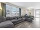 Spacious living room with gray sectional sofa and large windows at 21795 E 8Th Ave, Aurora, CO 80018