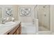 Bathroom featuring glass-enclosed shower and tub, a wide vanity, and white and gray tile at 10176 Park Meadows Dr # 2408, Lone Tree, CO 80124