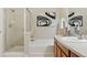 Bright bathroom featuring a glass-enclosed shower, tub, and stylish black and white artwork at 10176 Park Meadows Dr # 2408, Lone Tree, CO 80124