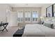 Well-lit bedroom featuring bright windows, a cozy bed with stylish throw pillows, and an elegant writing desk at 10176 Park Meadows Dr # 2408, Lone Tree, CO 80124