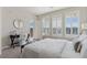 Bedroom with natural light, featuring a comfortable bed, writing desk, and access to a private balcony at 10176 Park Meadows Dr # 2408, Lone Tree, CO 80124