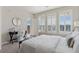 Bright bedroom with white bedding, desk, and terrace access at 10176 Park Meadows Dr # 2408, Lone Tree, CO 80124