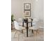 Bright dining area with a modern glass table and stylish white chairs at 10176 Park Meadows Dr # 2408, Lone Tree, CO 80124