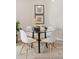 Modern dining area featuring a glass table, white chairs, and stylish wall art at 10176 Park Meadows Dr # 2408, Lone Tree, CO 80124